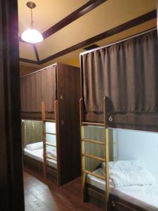 a room with three bunk beds and a light at Hostel Jan in the very center in Yerevan