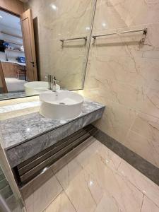 a bathroom with a sink and a mirror at New Modern Luxury Suite Apartment At The Heart of Vientiane in Vientiane