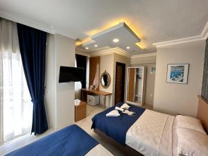 a bedroom with a large bed with a blue blanket at Serenity suites Hotel in Antalya