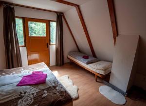 a small bedroom with a bed and a window at Enchanted Forest Chalet in Tatranska Strba