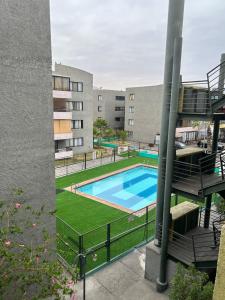 an image of a swimming pool in a building at Condominio Yucatán Iquique in Iquique