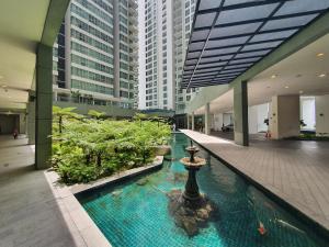 a large building with a fountain in the middle of it at Amazing KLCC View @ Regalia Residence in Kuala Lumpur