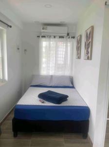 a bed with a blue mattress in a room at Sea Breeze inn 102 in Providencia