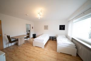 a living room with two beds and a table at DWK: Monteurhaus Bad Salzig in Boppard