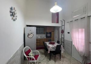 a kitchen with a table and chairs in a room at Casa Graziella in Brindisi