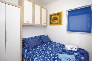a bedroom with a bed with blue sheets and a window at Harmony Drasnice in Drašnice