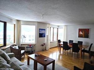 a living room with a couch and a table at Family penthouse with great view in Garðabær