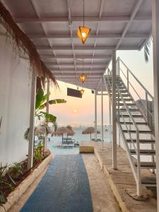 a staircase leading to the beach with a view of the ocean at Aqua Beach Rooms, only accommodation on Ashwem Beach in Mandrem