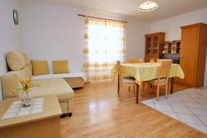 a living room with a table and a couch at Apartments Car Lj. in Šilo