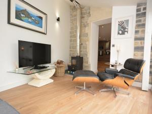 a living room with a tv and a table and chairs at 1 Bed in Curry Rivel 41489 in Curry Rivel