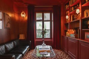 a living room with a couch and a glass table at Hôtel Particulier Montmartre in Paris +28 photos