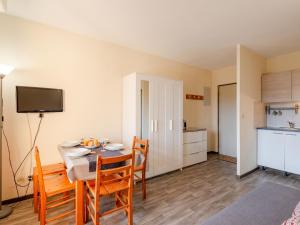 a room with a table and chairs and a kitchen at Apartment Les Pins Ensoleilles-7 by Interhome in Sainte-Maxime