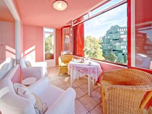 a living room with white furniture and a table at Apartment Muralla Roja-1 by Interhome in Calpe