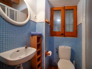 a bathroom with a sink and a toilet and a mirror at Holiday Home Sant Joan by Interhome in Calonge