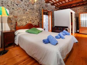 a bedroom with two beds with blue pillows on them at Holiday Home Sant Joan by Interhome in Calonge