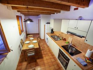 an overhead view of a kitchen with white cabinets at Holiday Home Sant Joan by Interhome in Calonge