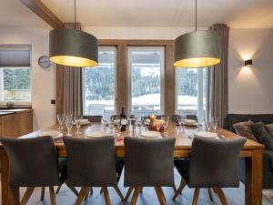 a dining room with a large wooden table and chairs at Holiday Home Steindlwald by Interhome in Untertauern