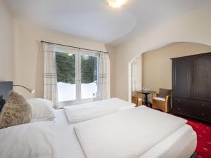 a bedroom with two white beds and a window at Holiday Home Steindlwald by Interhome in Untertauern