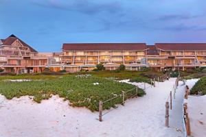a resort on the beach with a pathway to the beach at Dolphin Beach H106 by HostAgents in Bloubergstrand