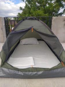 a green tent with a bed in it at Proyecto MOONLIGHT in Villavieja