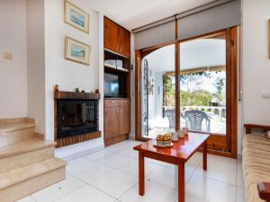 a living room with a fireplace and a table at Holiday Home Blanca by Interhome in Miami Platja