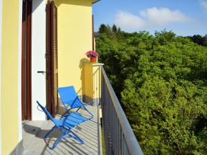 サヴォーナにあるApartment Faggio - SBO101 by Interhomeの植物のあるバルコニーの青い椅子