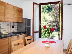 a kitchen with a table with a vase of flowers on it at Apartment Acero - SBO104 by Interhome in Savona