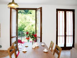 a dining room with a wooden table and chairs at Apartment Sambucco - SBO102 by Interhome in Savona