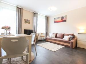 a living room with a couch and a table at Apartment Resident Harrachov B - HRA170 by Interhome in Harrachov