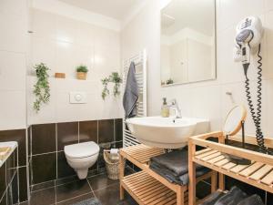 a bathroom with a white sink and a toilet at Apartment Resident Harrachov B - HRA170 by Interhome in Harrachov
