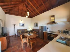 a kitchen and living room with a table and a couch at Casa Bayon in El Paso