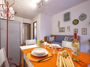 a living room with a table with a bottle of wine at Apartment D4 - A2 by Interhome in Santa Marinella