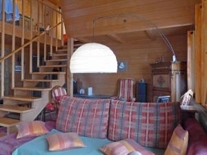 sala de estar con sofá y escalera en Chalet Mioche by Interhome, en Wengen