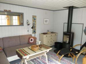 a living room with a couch and a stove at Holiday Home Berthabu - SOW116 by Interhome in Øyuvstad