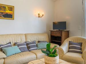 a living room with two couches and a television at Holiday Home Pen-er-Park by Interhome in Carnac