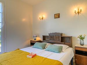 a bedroom with a large bed with two pillows at Holiday Home Pen-er-Park by Interhome in Carnac