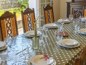 a table with plates and glasses on a blue and white table cloth at Holiday Home Pen-er-Park by Interhome in Carnac +15 photos