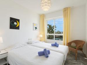 two beds in a room with a window at Apartment Lorcrisur by Interhome in Marbella