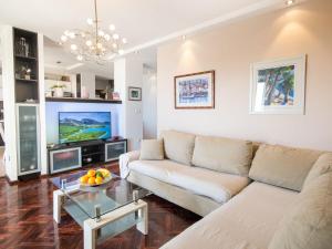 a living room with a couch and a table at Holiday Home Drago by Interhome in Veliko Brdo
