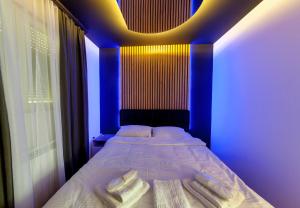 a bedroom with a bed with two towels on it at Luxury Residence in Belgrade