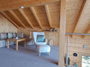 a living room with a couch and a chair at Chalet Dolzer by Interhome in Hochrindl