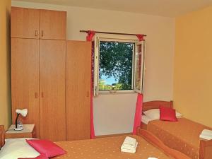 a small bedroom with two beds and a window at Holiday Home Mario-1 by Interhome in Makarska