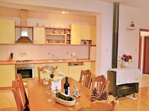 a kitchen with a table with a bottle of wine at Holiday Home Mario-1 by Interhome in Makarska