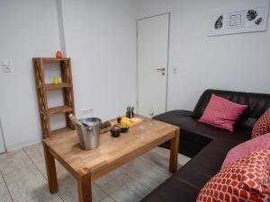a living room with a coffee table and a couch at Apartment Backbord by Interhome in Norddeich