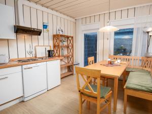 a kitchen and dining room with a wooden table at Apartment Backbord by Interhome in Norddeich