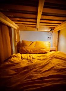 an unmade bed in a room with a wooden bunk bed at Camp Hillcrest Bunkhouse 