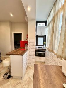 a kitchen with white cabinets and a counter top at Nataly New luxury apartment on Black sea in Varna City