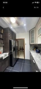 a kitchen with a stainless steel refrigerator in it at Departamento amplio para familias in Guayaquil