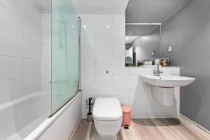a white bathroom with a toilet and a sink at Luxury 3 Bedroom Flat in Mayfair London HY4 in London