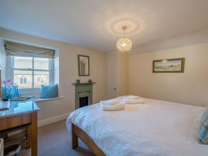 a bedroom with a large white bed and a fireplace at 2 Bed in Satterthwaite and Grizedale LLH56 in Grizedale